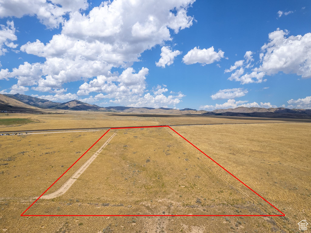 Aerial view featuring a rural view and a mountain view