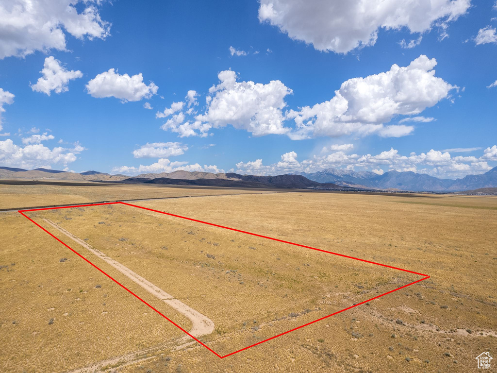 Birds eye view of property with a rural view and a mountain view