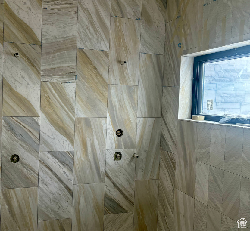 Room details featuring tiled shower