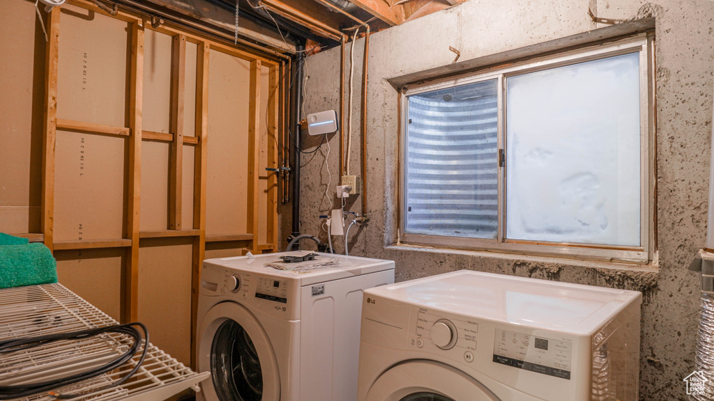 Laundry area featuring a healthy amount of sunlight and washer and clothes dryer