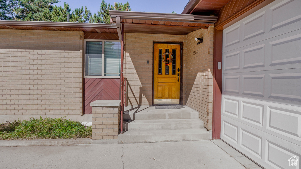 View of exterior entry featuring a garage