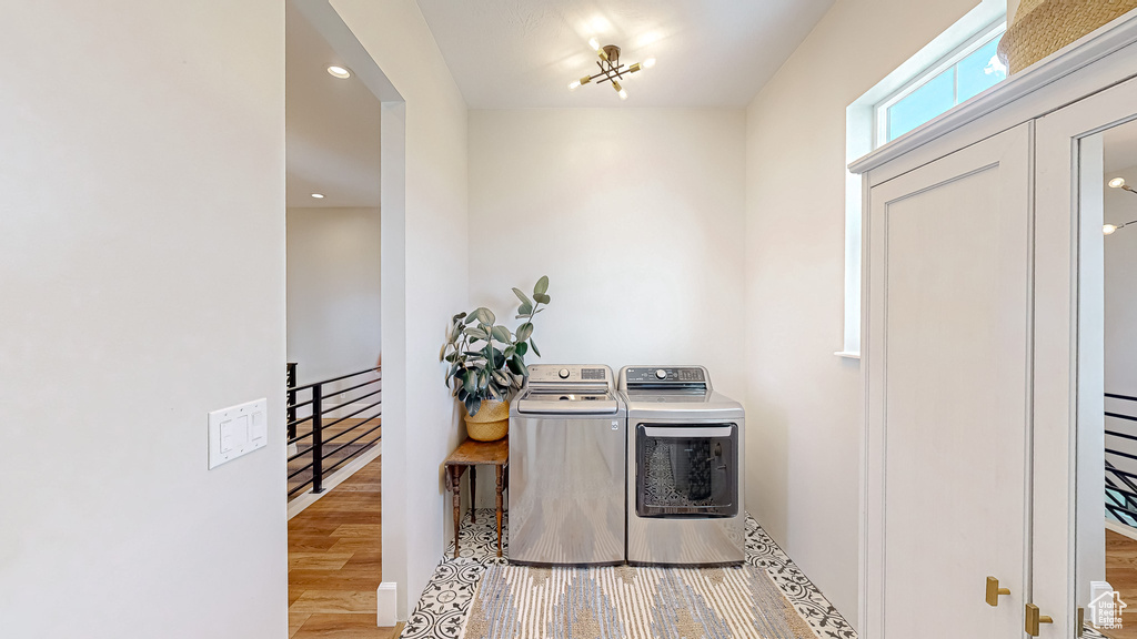 Interior space with light wood-type flooring and washing machine and dryer