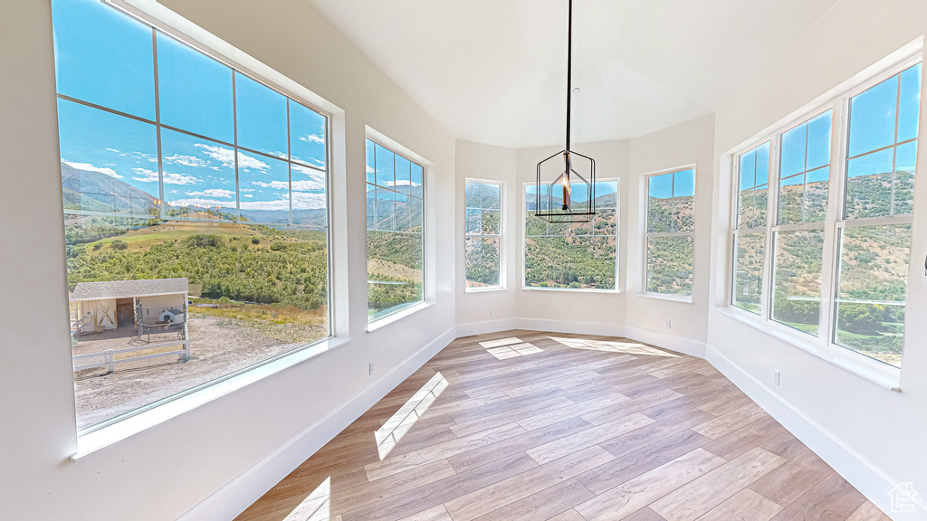 Unfurnished sunroom with a chandelier