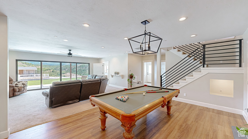 Game room with ceiling fan, pool table, and light hardwood / wood-style flooring