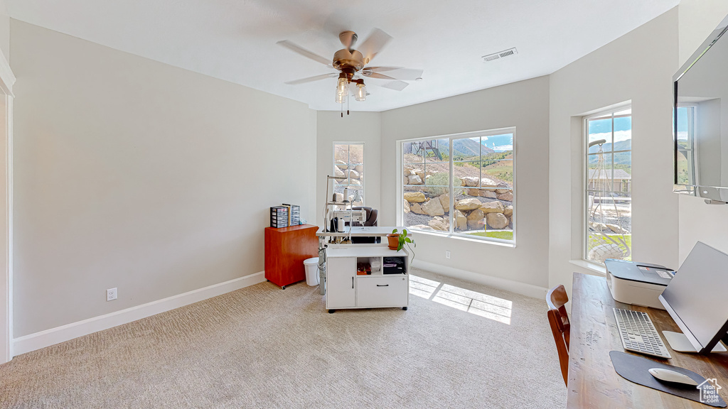 Office space featuring ceiling fan and light carpet