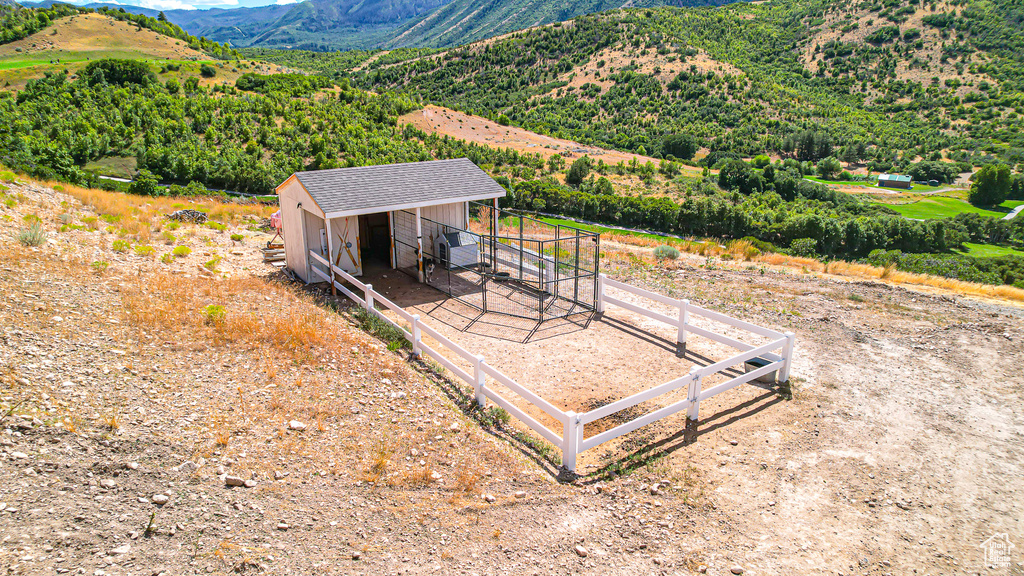 Exterior space featuring a mountain view and an outdoor structure