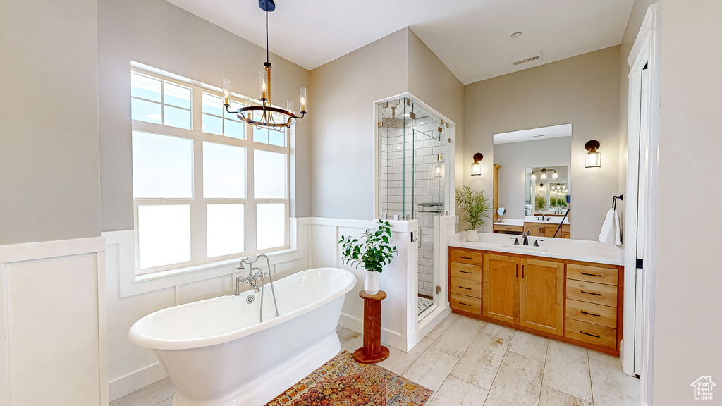 Bathroom featuring a healthy amount of sunlight, vanity, separate shower and tub, and tile patterned floors