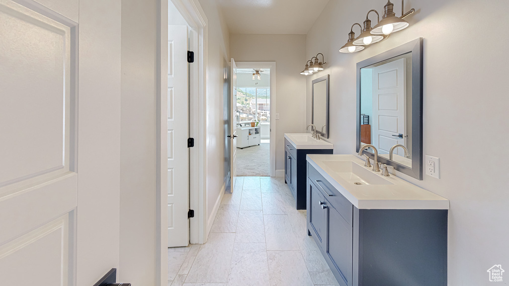 Bathroom with tile patterned floors, vanity, and ceiling fan