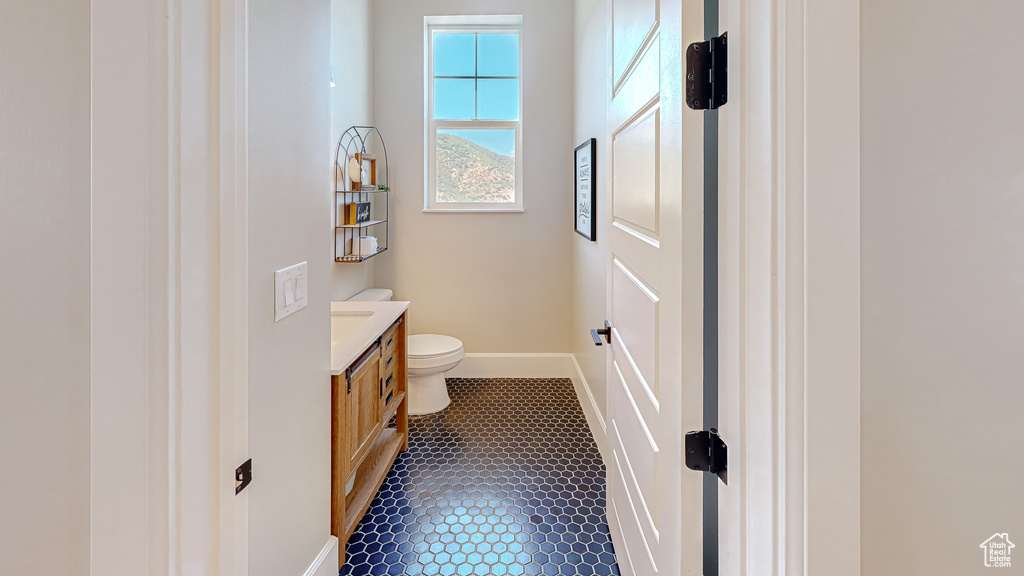 Bathroom featuring tile patterned floors, vanity, and toilet