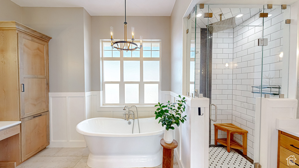 Bathroom with separate shower and tub, vanity, and plenty of natural light