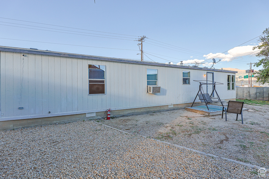 Back of house featuring cooling unit