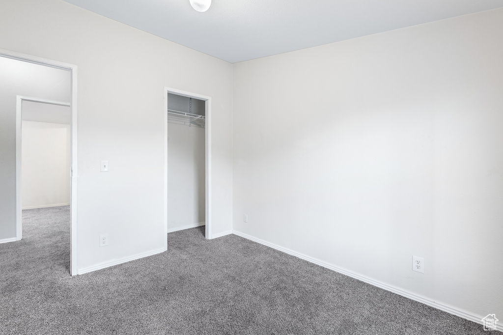 Unfurnished bedroom featuring carpet and a closet