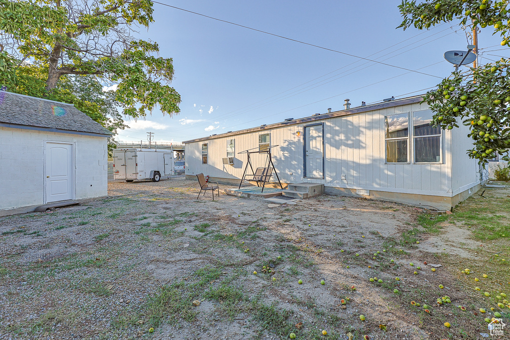 Rear view of property with a shed