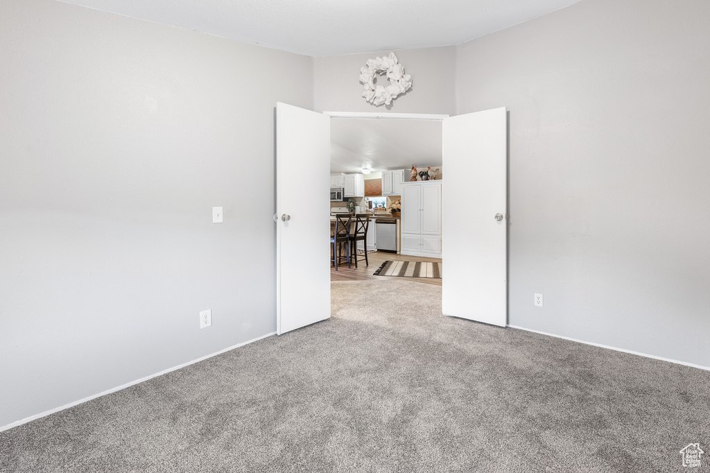 Unfurnished room with light colored carpet