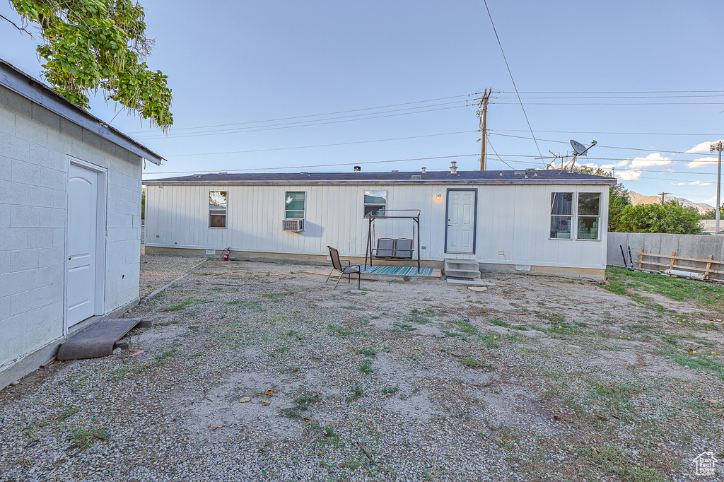 Rear view of property featuring cooling unit