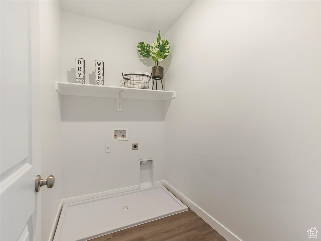 Clothes washing area with washer hookup, wood-type flooring, and hookup for an electric dryer