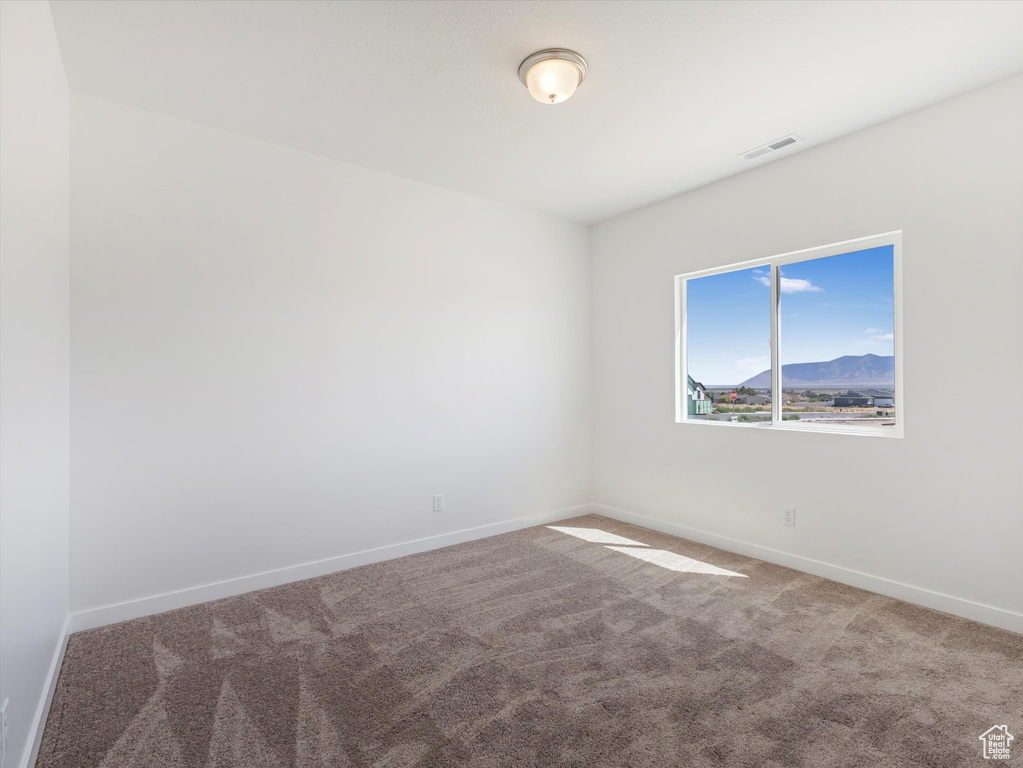 Empty room featuring carpet floors