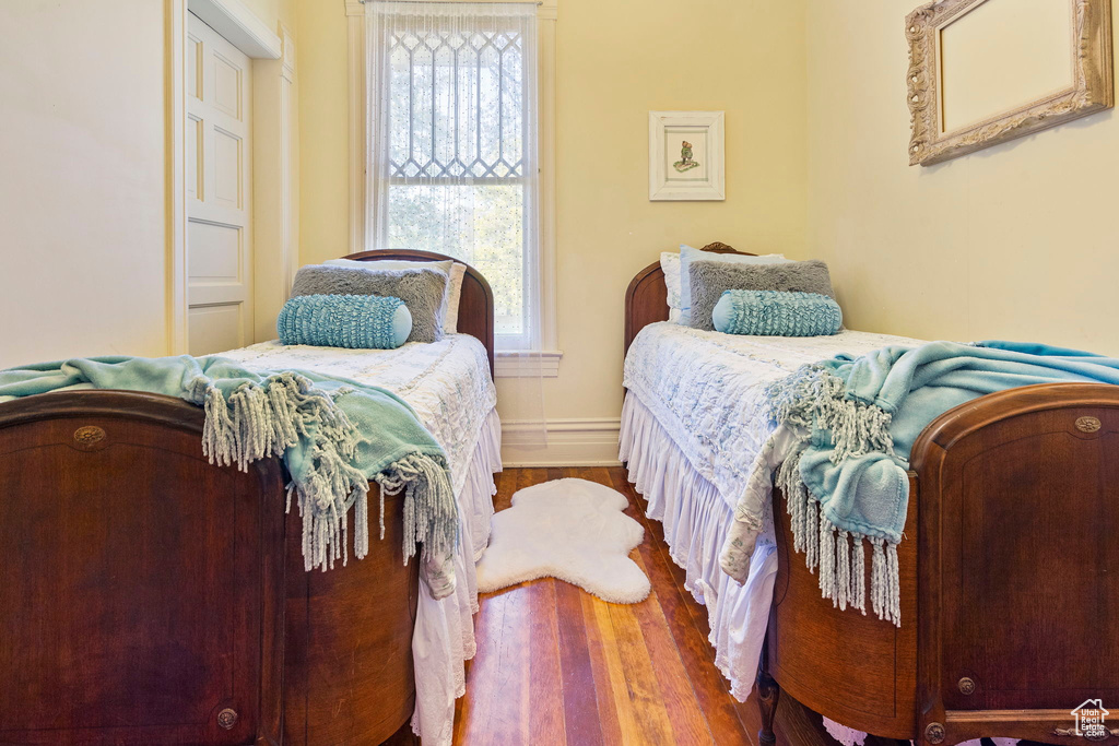 Bedroom featuring wood-type flooring and multiple windows