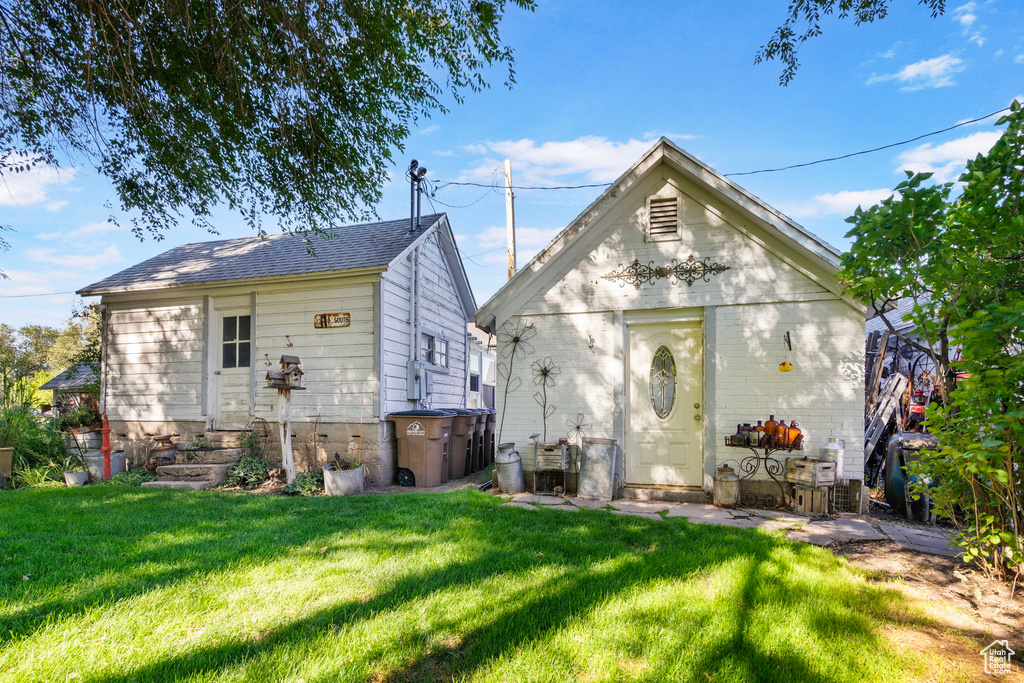 Back of property featuring a yard