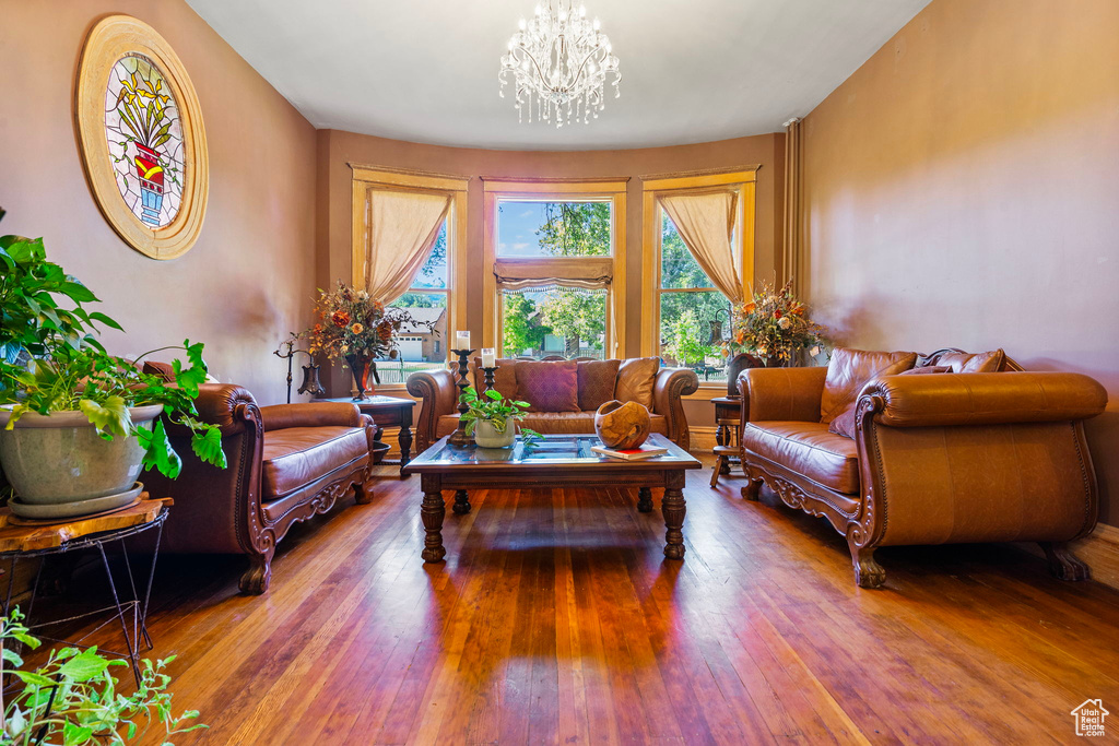 Living room featuring a chandelier and wood-type flooring