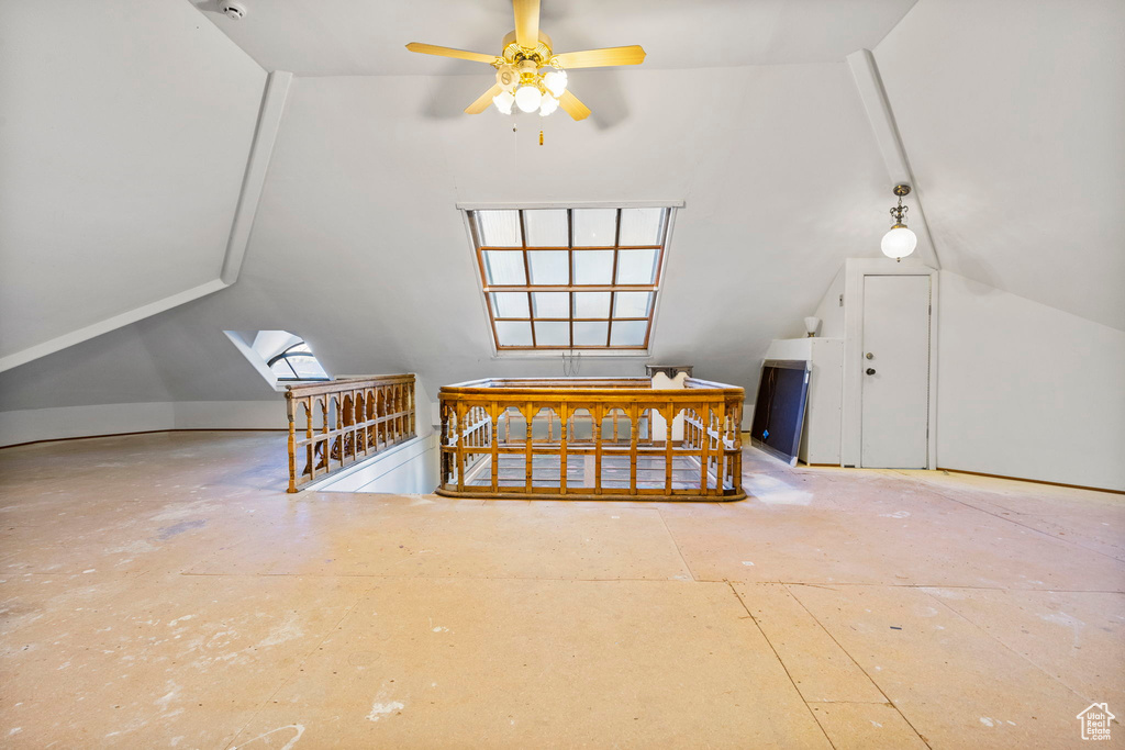 Additional living space featuring vaulted ceiling with skylight and ceiling fan