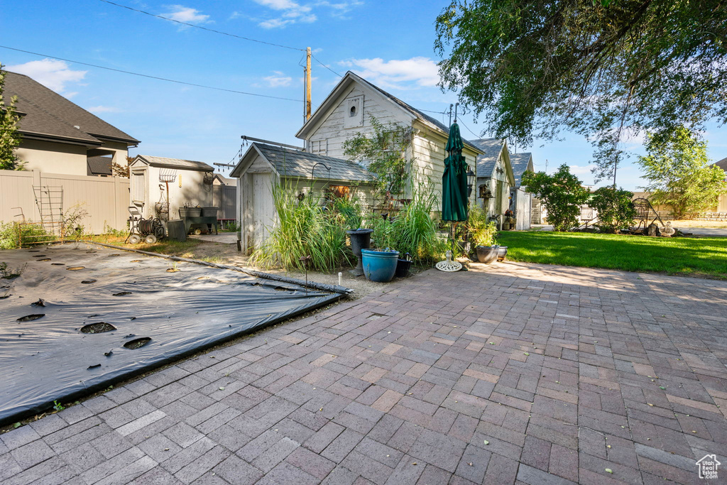 View of patio with a storage shed