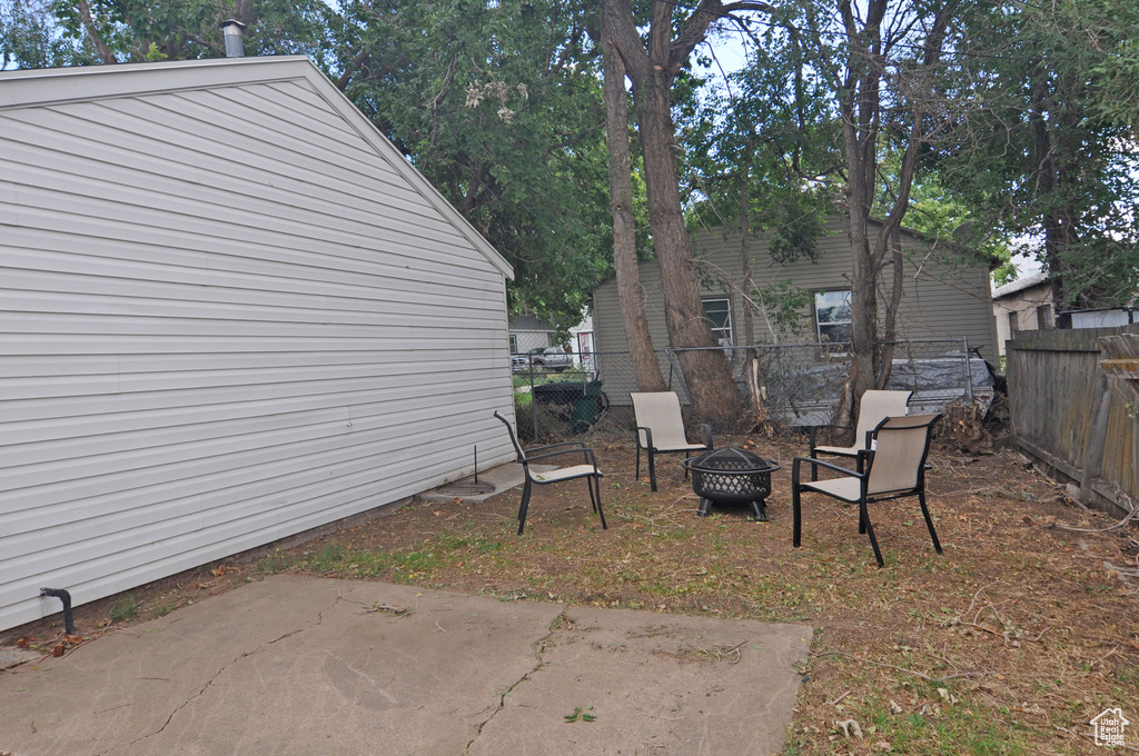 View of yard featuring a patio and a fire pit