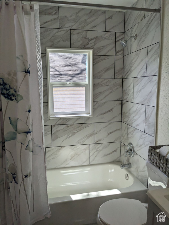 Full bathroom featuring shower / bath combo, toilet, and vanity