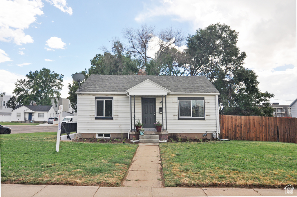 Bungalow-style house featuring a front lawn