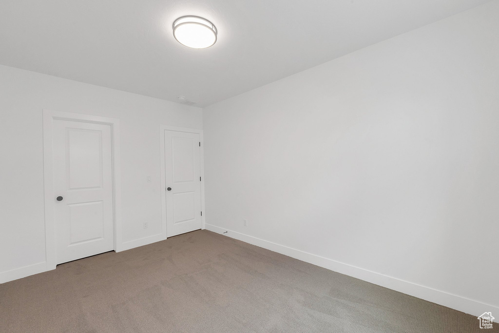 Unfurnished room with carpet flooring