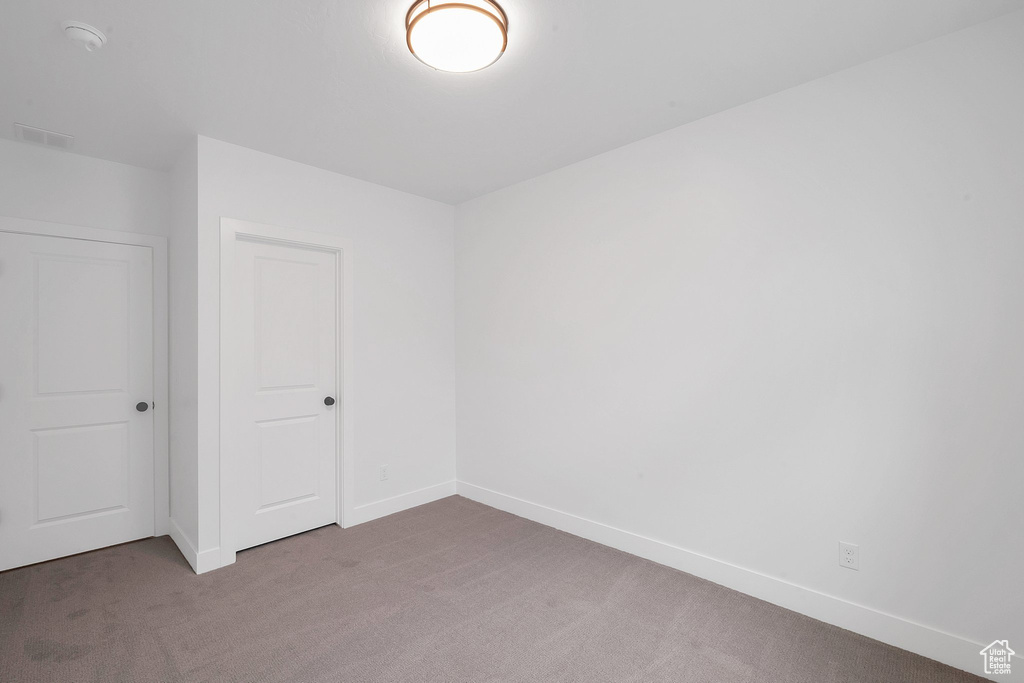 Interior space featuring a closet and carpet flooring