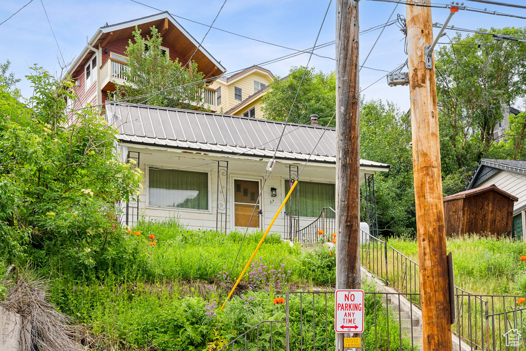 View of front of home with a balcony and a porch