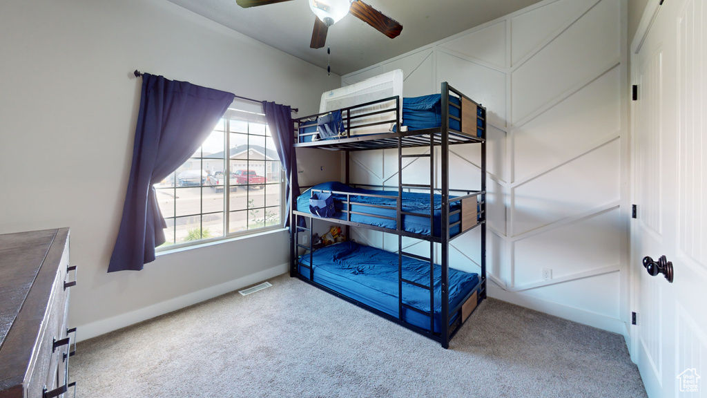 Bedroom featuring ceiling fan and light carpet