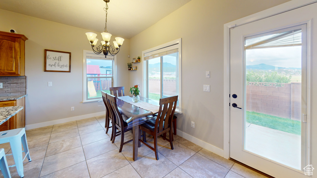 Tiled dining area with an inviting chandelier