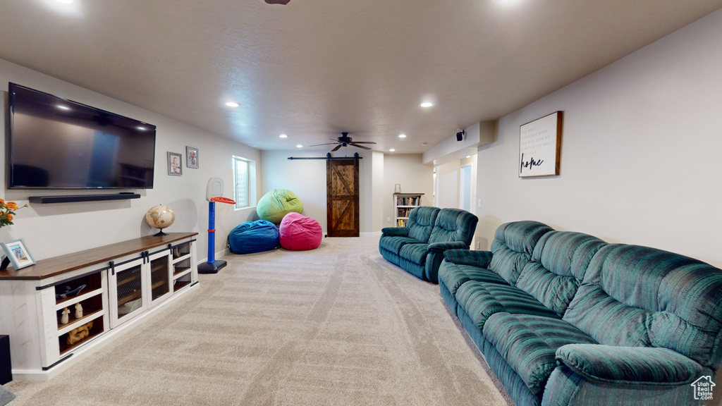 Carpeted living room featuring ceiling fan