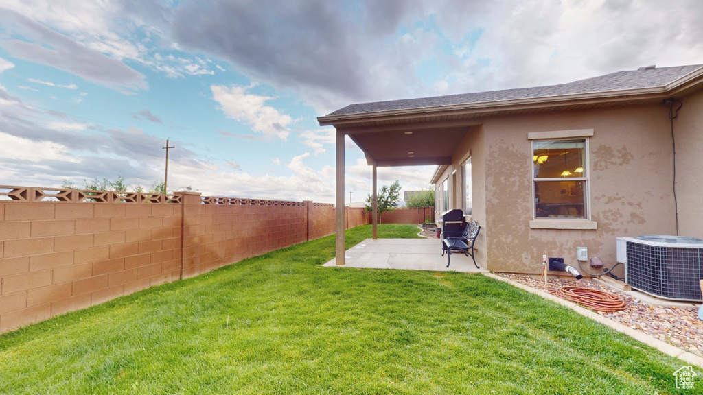 View of yard with a patio area and central air condition unit