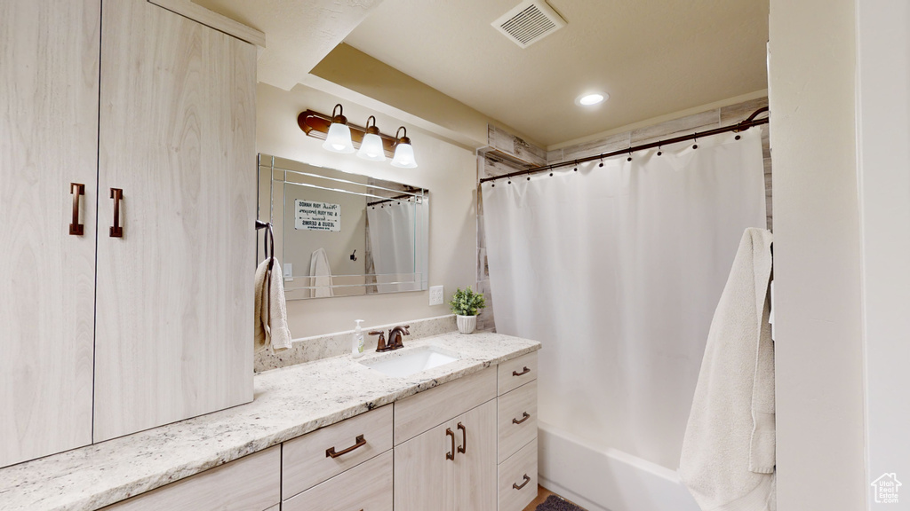 Bathroom with vanity and shower / bath combo