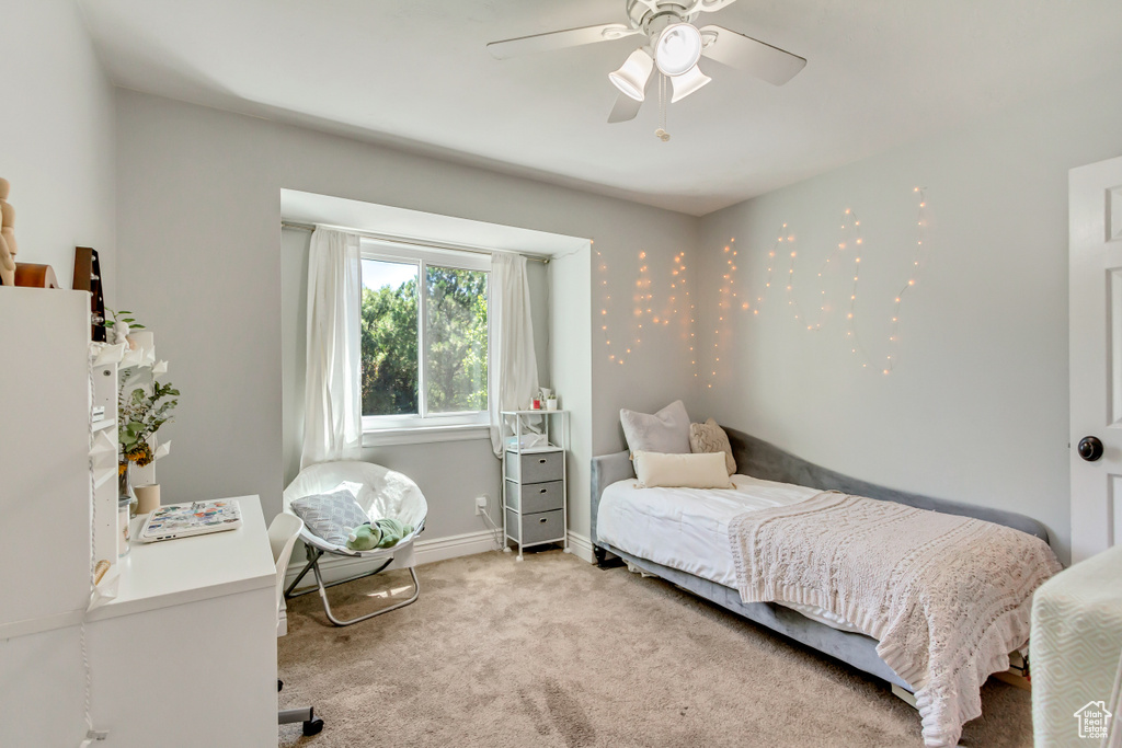 Carpeted bedroom with ceiling fan