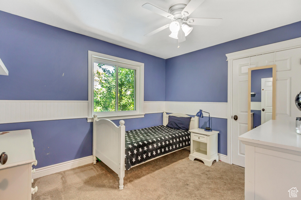 Carpeted bedroom with ceiling fan