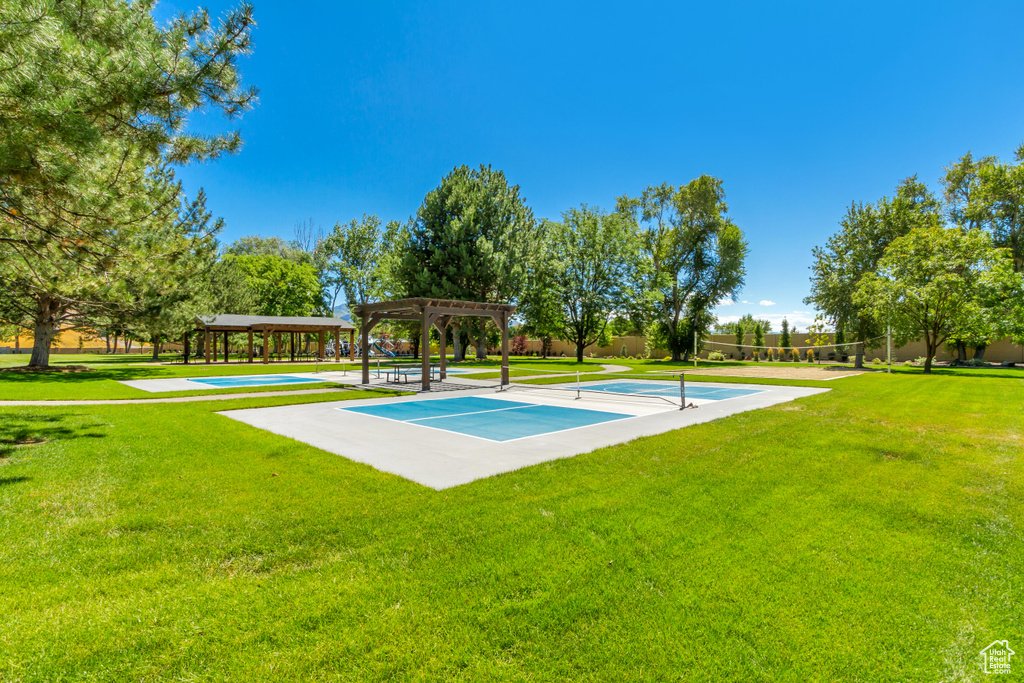 View of basketball court featuring a lawn and a pergola