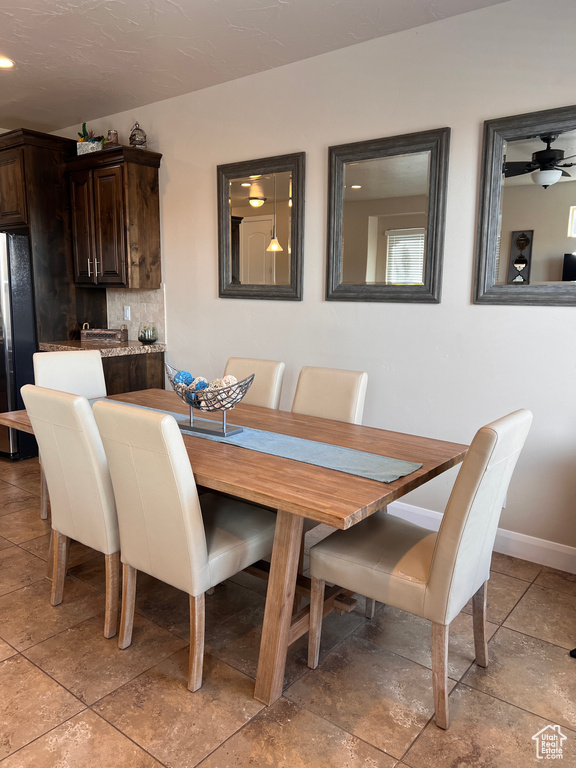 Dining area with ceiling fan and light tile patterned flooring