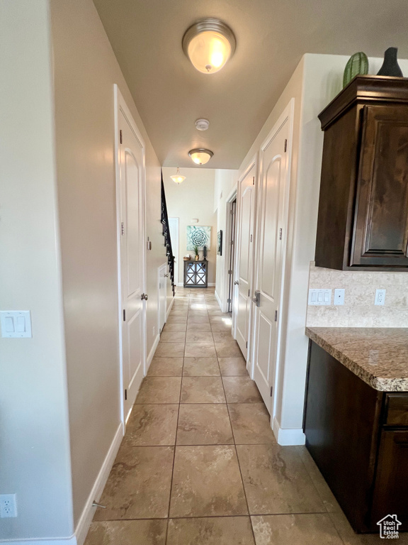 Corridor with light tile patterned floors