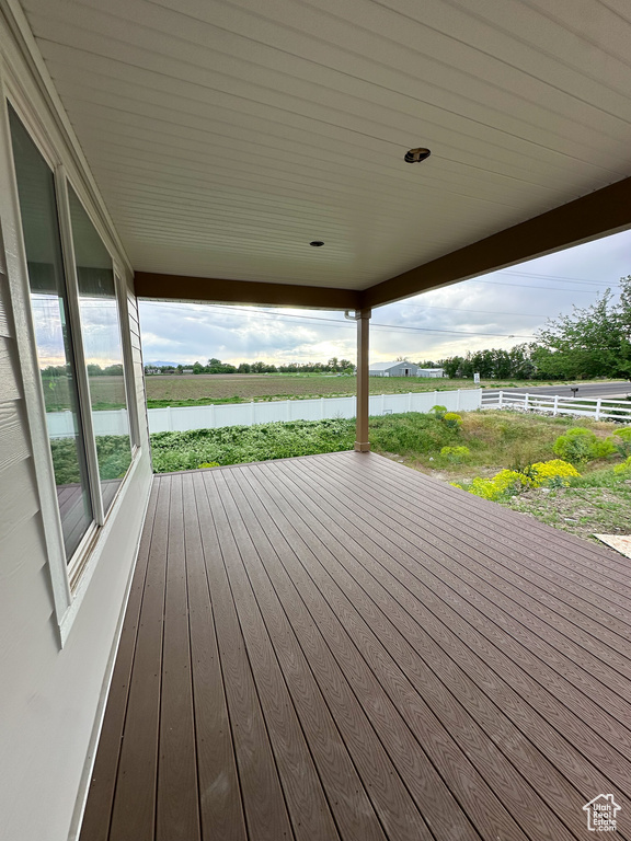 Wooden terrace featuring fence and a water view