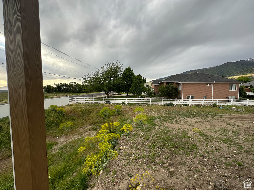 View of yard with fence and a mountain view