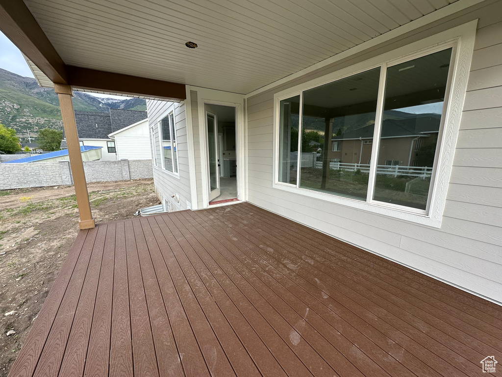 Wooden terrace featuring a mountain view and fence
