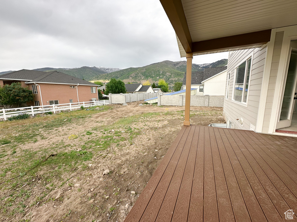 Wooden terrace featuring a mountain view and fence