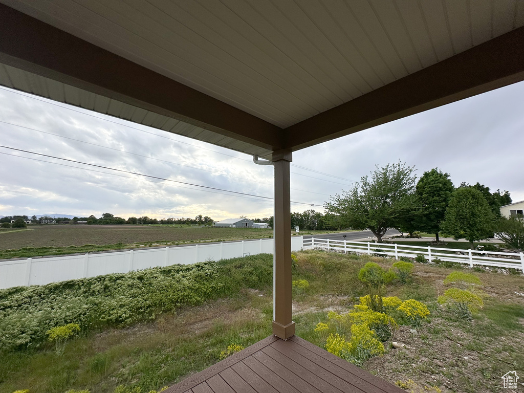 Wooden terrace featuring fence