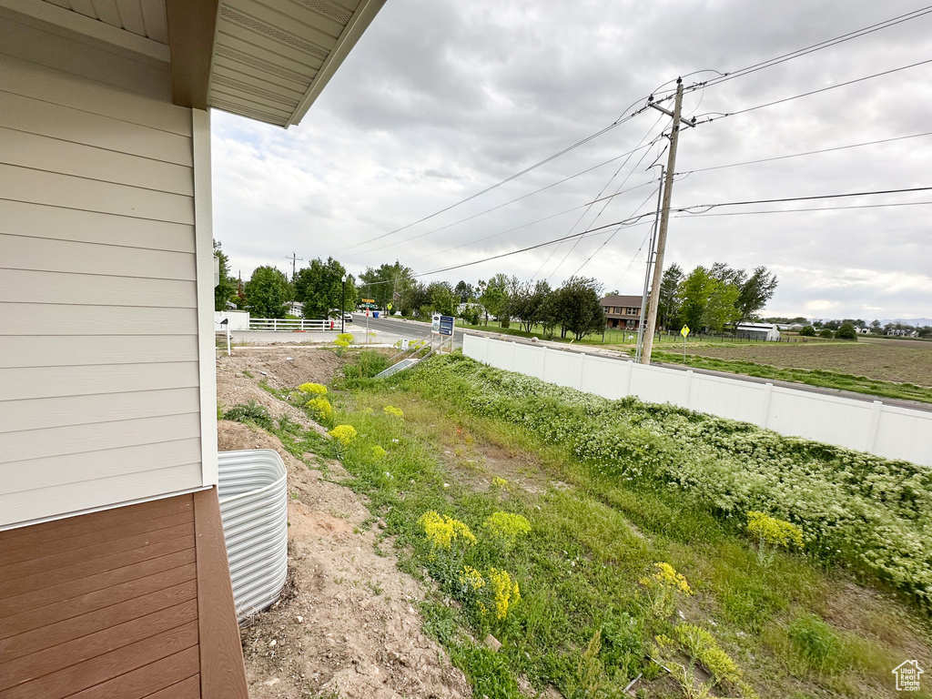 View of yard with fence and central AC