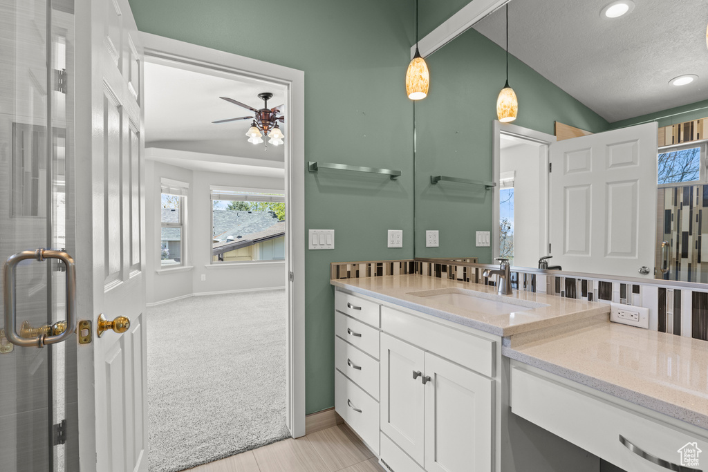 Full bathroom featuring vanity, a ceiling fan, a healthy amount of sunlight, and recessed lighting