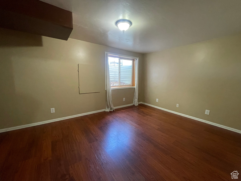 Spare room featuring dark hardwood / wood-style floors